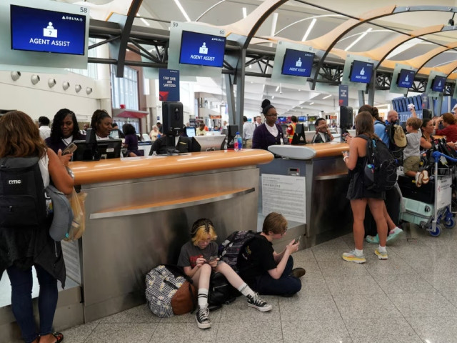 people speak to delta agents as they try to rebook their travel plans after long delays following cyber outages affecting airlines at hartsfield jackson atlanta international airport in atlanta georgia us july 22 2024 photo reuters